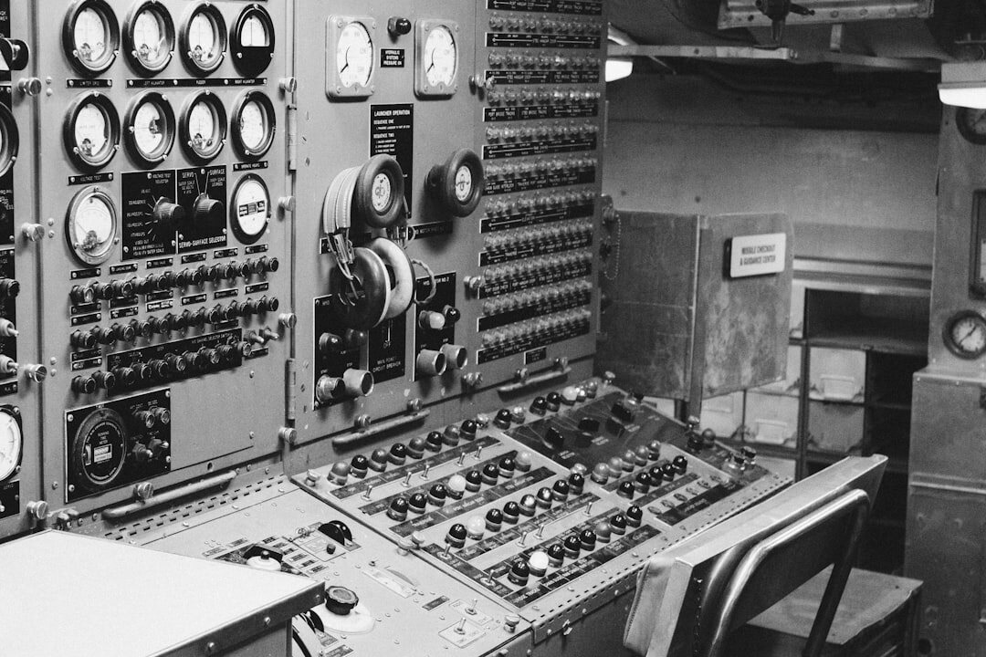 Broadcast engineer adjusting a signal router in a technical rack room